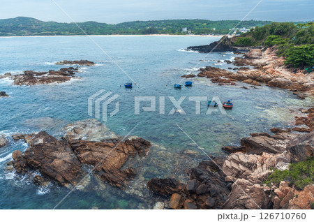 Seascape with Vietnamese round basket boats floating in the sea next to the rocks. Panoramic landscape of Da Da reef or Ganh Da Dia in Phu Yen province in Vietnam. Aerial top view from drone Seascape with Vietnamese round basket boats floating in the sea next to the rocks. Panoramic landscape of Da Da reef or Ganh Da Dia in Phu Yen province in Vietnam. Aerial top view from drone 126710760