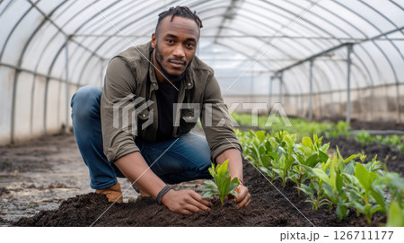 Thinking farmer afro with digital tablet checking sustainable farming growth, progress or preparing farm export order on tech. Serious man, gardener or greenhouse environmental scientist on a rural 126711177