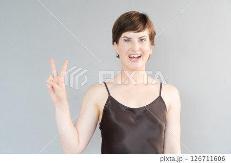 Happy young girl isolated over gray background 126711606