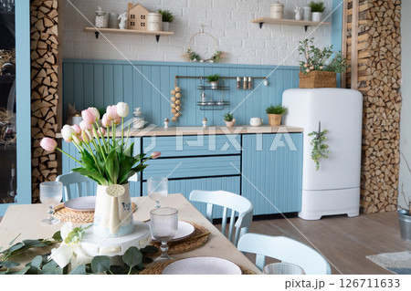 Discover a Charming Modern Kitchen that features Cozy Decor complemented by an Elegant Floral Arrangement 126711633