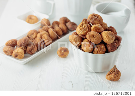 Organic dried figs on a white table. 126712001