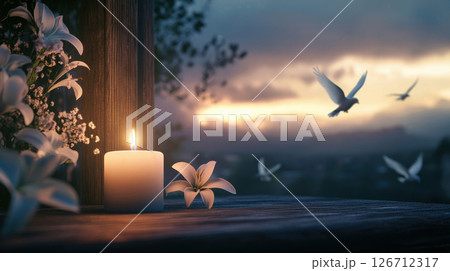 Peaceful candle memorial scene with white lilies and soft sunset light for funeral template use 126712317