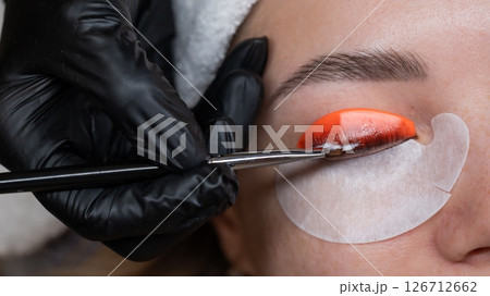 Caucasian woman undergoing eyelash lamination procedure. Caucasian woman undergoing eyelash lamination procedure. 126712662