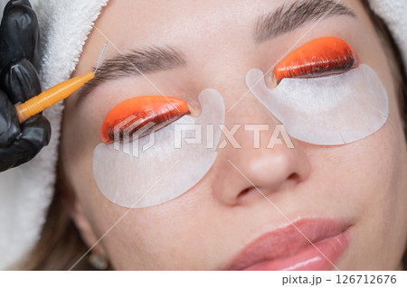 Caucasian woman undergoing eyelash lamination procedure. Caucasian woman undergoing eyelash lamination procedure. 126712676