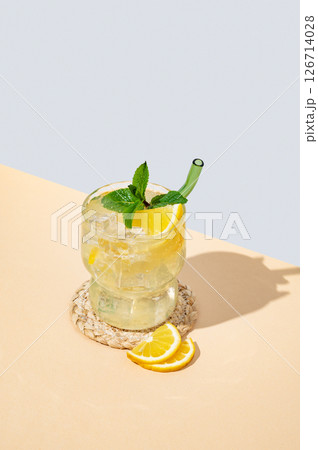 Fresh mocktail mojito with lemon, mint and ice. Citrus lemonade on a blue yellow background. 126714028