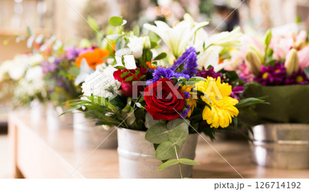 Bouquet of flowers in a vase on the table 126714192