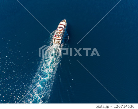 Top above aerial drone view luxury motor yacht sailing in turquoise blue sea water Mediterranean landscape background on sunny summer day.  Motor boat ship charter rental trip insurance 126714536