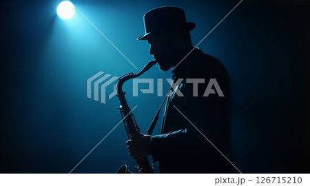 Silhouetted Jazz Saxophonist in Fedora Performs Under Luminous Blue Moonlit Stage Silhouetted Jazz Saxophonist in Fedora Performs Under Luminous Blue Moonlit Stage 126715210