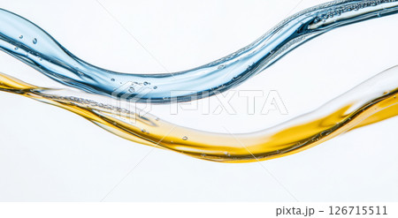 Close-up of blue and yellow liquid flowing on white background 126715511