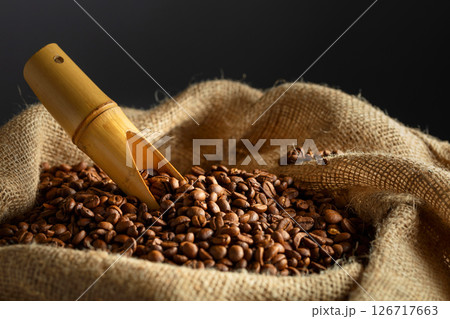 Roasted coffee beans in burlap bag. 126717663