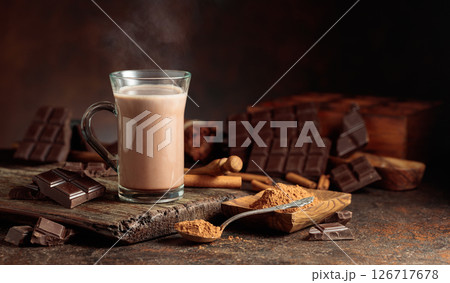 Creamy hot chocolate drink on a brown background. 126717678