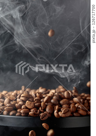 Steaming coffee beans in movement. 126717700