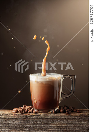 Coffee and chocolate drink with cream on a brown background. Coffee and chocolate drink with cream on a brown background. 126717704