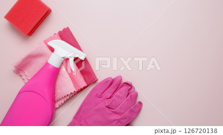 Household cleaning and hygiene concept. Pink cleaning supplies including rubber gloves, spray bottle, sponge, microfiber cloths Household cleaning and hygiene concept. Pink cleaning supplies including rubber gloves, spray bottle, sponge, microfiber cloths 126720138