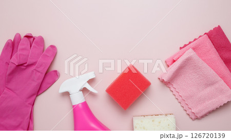Household cleaning and hygiene concept. Pink cleaning supplies including rubber gloves, spray bottle, sponge, microfiber cloths 126720139
