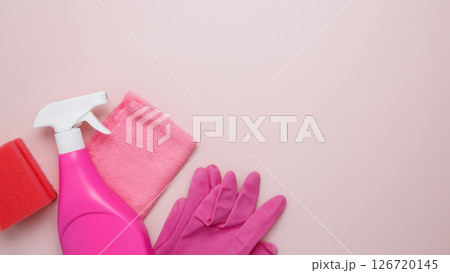 Household cleaning and hygiene concept. Pink cleaning supplies including rubber gloves, spray bottle, sponge, and microfiber cloths 126720145