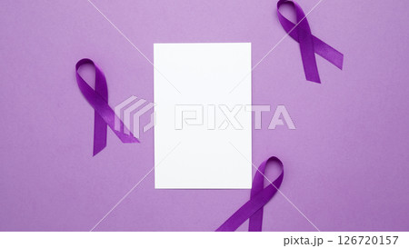 Mock up notebook. Purple Epilepsy Awareness Day, purple ribbon held, symbol of support Mock up notebook. Purple Epilepsy Awareness Day, purple ribbon held, symbol of support 126720157