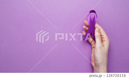 Purple ribbon held, symbol of support. Purple Epilepsy Awareness Day Purple ribbon held, symbol of support. Purple Epilepsy Awareness Day 126720158