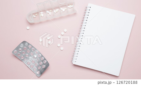 Concept of medicine, healthcare, and pharmaceutical industry. Blister of tablets and blank notebook Concept of medicine, healthcare, and pharmaceutical industry. Blister of tablets and blank notebook 126720188