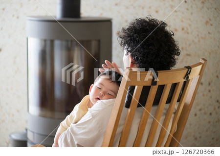 赤ちゃんを抱っこして寝かしつけるパパさんのイメージ 赤ちゃんを抱っこして寝かしつけるパパさんのイメージ 126720366