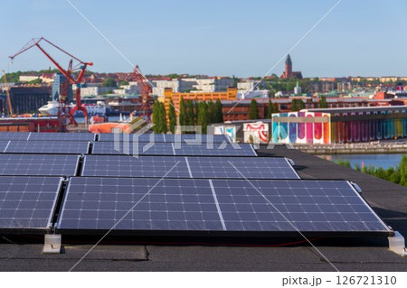 Solar panels on roof of apartment housing building with Gothenburg city center in background, Sweden, renewable green sustainable energy concept Solar panels on roof of apartment housing building with Gothenburg city center in background, Sweden, renewable green sustainable energy concept 126721310