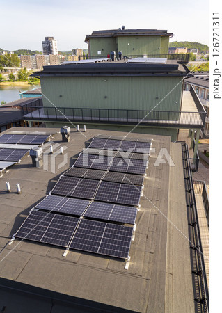 Solar panels on roof of apartment housing building with Gothenburg city center in background, Sweden, renewable green sustainable energy concept Solar panels on roof of apartment housing building with Gothenburg city center in background, Sweden, renewable green sustainable energy concept 126721311