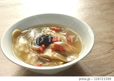 boiled slice Chinese bamboo shoot with goji berry and mushroom clear soup on bowl boiled slice Chinese bamboo shoot with goji berry and mushroom clear soup on bowl 126721589