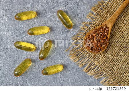 Flax seeds. Flaxseed powder in a wooden spoon. Standing on a Wooden background. Flax seeds. Flaxseed powder in a wooden spoon. Standing on a Wooden background. 126721869