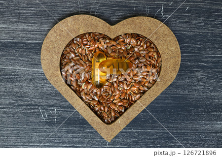 Flax seeds. Flaxseed powder in a wooden spoon. Standing on a Wooden  background. Flax seeds. Flaxseed powder in a wooden spoon. Standing on a Wooden  background. 126721896