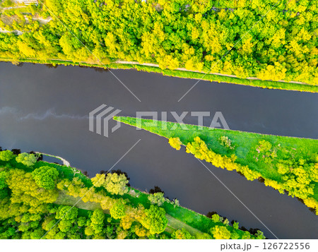This aerial view showcases the confluence of the Vltava and Labe rivers near Melnik, Czechia, surrounded by lush greenery and vibrant landscapes during a clear day. This aerial view showcases the confluence of the Vltava and Labe rivers near Melnik, Czechia, surrounded by lush greenery and vibrant landscapes during a clear day. 126722556