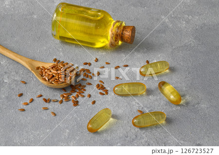 Flax seeds. Flaxseed powder in a wooden spoon. Standing on a Wooden background. 126723527