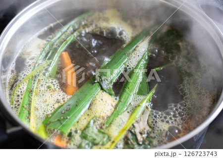 Simmering Delicious Ingredients Together for a Flavorful Broth Full of Herbs and Vegetables 126723743