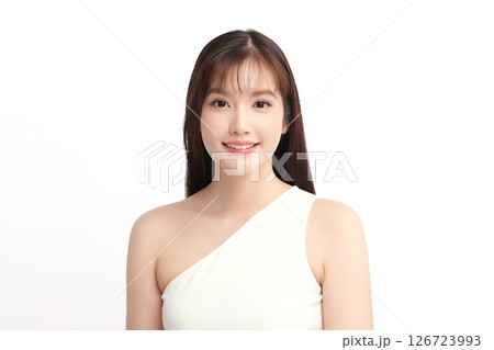 A beautiful young Asian woman with clean, fresh skin against a white background. Skincare, facial treatment, cosmetology, beauty, and spa. An elegant portrait of an Asian woman. 126723993