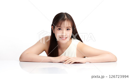 A beautiful young Asian woman with clean, fresh skin against a white background. Skincare, facial treatment, cosmetology, beauty, and spa. An elegant portrait of an Asian woman. 126723994