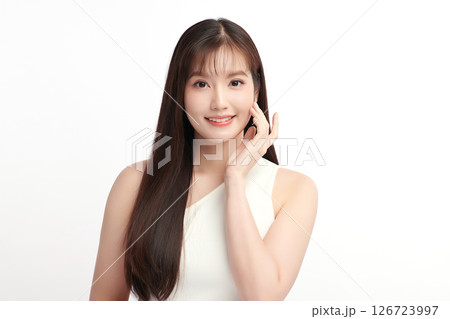 A beautiful young Asian woman with clean, fresh skin against a white background. Skincare, facial treatment, cosmetology, beauty, and spa. An elegant portrait of an Asian woman. 126723997