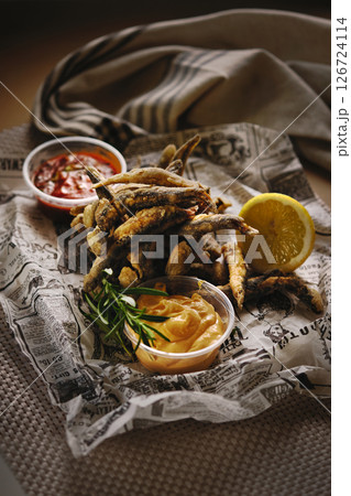 Rustic fried anchovies with dipping sauces and beer 126724114