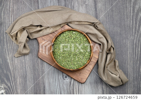 Dry mint in wooden spoon isolated on wooden background 126724659