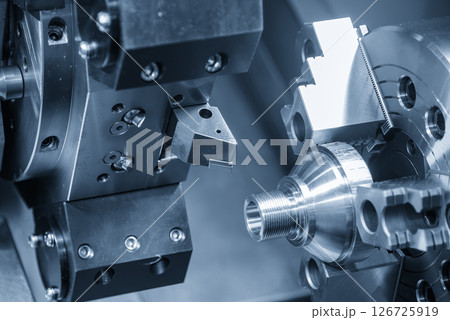The CNC lathe machine forming  cutting the metal shaft parts. The CNC lathe machine forming  cutting the metal shaft parts. 126725919