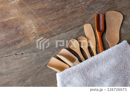 Set of wooden spoons are different kinds in towel on wooden. Set of wooden spoons are different kinds in towel on wooden. 126726073