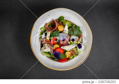 Salad mix with jamon, baby mozzarella, strawberries and vinaigrette sauce. Salad mix with jamon, baby mozzarella, strawberries and vinaigrette sauce. 126726201