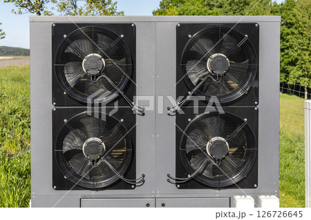 Commercial air source heat pump system installed outdoors. These systems are common in energy-efficient HVAC solutions and are increasingly used in modern sustainable architecture. 126726645