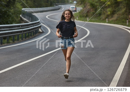 Woman running on a bendy road 126726879