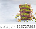 Stack of chocolate bars with pistachio and kadaifi filing, horizontal copy space 126727898