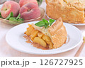 Old fashioned deep dish peach pie slice garnished with fresh mint, on white plate, horizontal 126727925