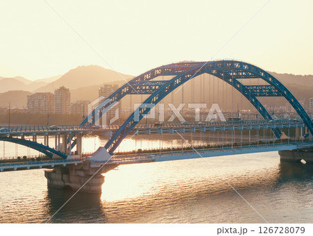 Aerial view of a bridge over a river with cars commuting at sunset. Hangzhou, China. 126728079