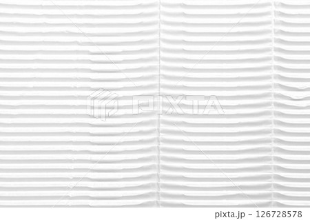 White folded ribbed corrugated wrapping paper. Textured rough cardboard surface. Abstract background with geometric linear pattern White folded ribbed corrugated wrapping paper. Textured rough cardboard surface. Abstract background with geometric linear pattern 126728578