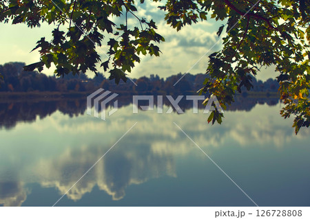 Beautiful landscape lake with clouds and autumn leaves reflected in it. Forest reservoir. Beautiful landscape lake with clouds and autumn leaves reflected in it. Forest reservoir. 126728808