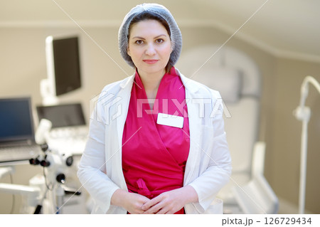 Portrait of female obstetrician gynecologist in office during appointment of patient. Portrait of female obstetrician gynecologist in office during appointment of patient. 126729434