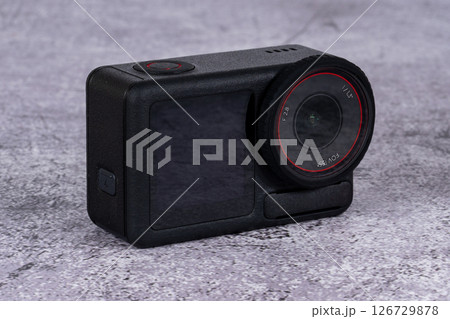 black action camera front view placed on the table 126729878