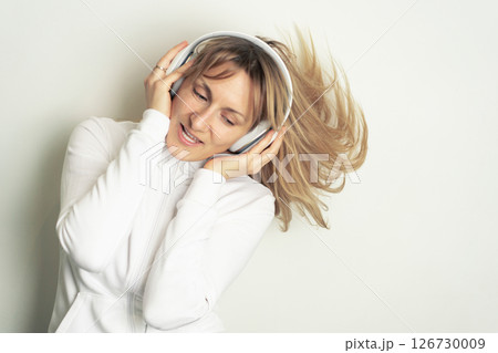 Woman enjoying music with headphones 126730009